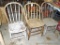 Three neat old wooden kitchen chairs, similar styles but a little different sizes. One is stripped