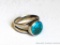 Ladies ring with turquoise accent is about a ladies size 8. No markings found.