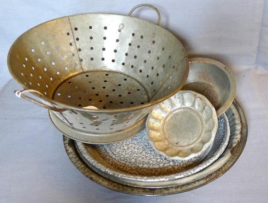 Two graniteware enameled pie plates, plus a dinner plate; Also a colander, small pie plate and a