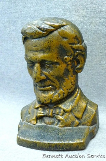 Cast iron book end, bust of Abe Lincoln; measures 4-1/2" x 2-3/4" x 6" tall.
