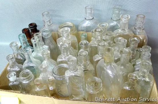 Collection of antique bottles range in size from 2-3/4" tall to a 7" tall bottle marked 'Half Pint