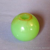 We think this green glass piece may have been a lamp accent and measures 1-3/4