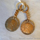 Two copper toned key chains from Park Falls Oil Co. depicting a 1943 penny on the reverse. Each is