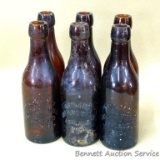 Six antique cast glass beer bottles marked Ashland Bottling Works, Ashland Wis. Each measures 2-1/2