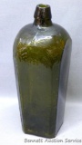 Olive green bitters bottle with flower or cross pattern on the bottom. Dump dug bottle has some