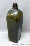 Olive green bitters bottle with circle and five dots pattern on the bottom. Dump dug bottle has a