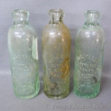 Three heavy antique bottles all marked 'Park Falls Bottling Works, Park Falls, Wis.'. Each bottle is