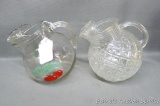 Two vintage ball style juice pitchers - one with a quilted pattern and one with tomato and leafy