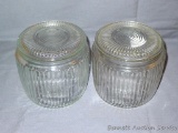 Two matched ribbed glass jars with lids. One is marked with the Anchor Hocking logo on the bottom.