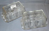 Two glass one pound butter dishes are in good condition overall with only small chips noted on each.