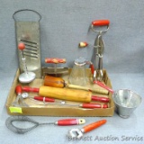 Vintage red handled kitchen utensils including Nesco multi tool; syrup pitcher, rolling pin, masher,