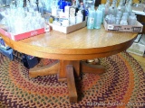 Nice round oak pedestal table is very sturdy and in overall good condition. Table is 56