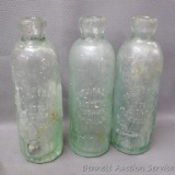 Three antique green glass bottles from 'Park Falls Bottling Works, Park Falls, Wis.'. Each bottle