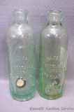 Two antique green glass bottles from 'Park Falls Bottling Works, Park Falls, Wis.'. Each bottle