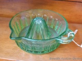 Pretty green glass juicer or reamer is in good condition with a rough edge between handle and spout.