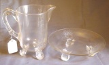 Footed glass pitcher and footed dish in good condition. Pitcher stands 9-1/4