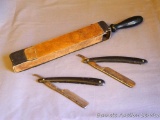 Two straight razors, plus a razor strop. One razor is marked Made in Germany on one side and '1720