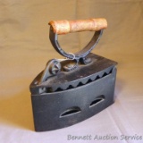 Cast iron iron keeper or caddy has a trivet inside, wooden handle and a unique latch. Measures