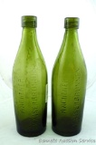 Two cast glass bottles have internal threads, read 'A Achener Kaiserbrunnen'. Glass is wavy and