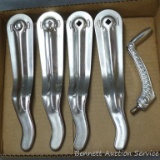 Four chromed slot machine handles appear to fit Mills Novelty Co. machines. Also includes a hex