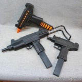 Three uzi squirt guns from back in the day. Largest is 20