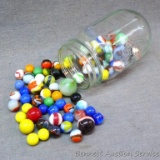 Jar over half full of old marbles - solids, stripes, others.