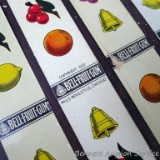 Metal slot machine strips by Mills Novelty Co. Chicago, Copyright 1910 are labeled 'Bell-Fruit-Gum'