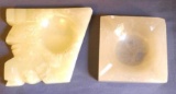 Two ashtrays made of marble or similar. Larger ashtray depicts a Native American face and measures
