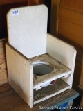 Vintage wooden potty chair with little enameled chamber pot. Chair measures approx. 13