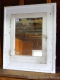 Built in medicine cabinet with wide frame and mirrored door. Measures 29