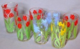 Six little juice glasses dating to the early 1940s, plus another taller glass. Three glasses have