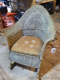 Child's wicker rocker with upholstered seat. Rocker stands approx. 26