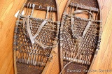 Handmade antique snowshoes are over 3' long.