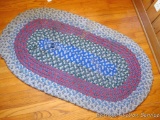 Braided throw rug is approx 4-1/2'x 2-1/2' and needs a few stitches; nice colors.