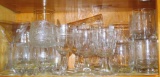 Stemware and tumblers including a few Crown Royal tumblers, Flintstones cup, pilsners, wine glasses