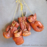 Two pair of vintage leather boxing gloves by Town and Country, made in Pakistan. Both look to be in
