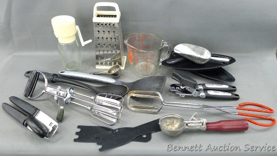 2 cup Anchor Hocking measuring cup, grater, nut grinder and assorted utensils.