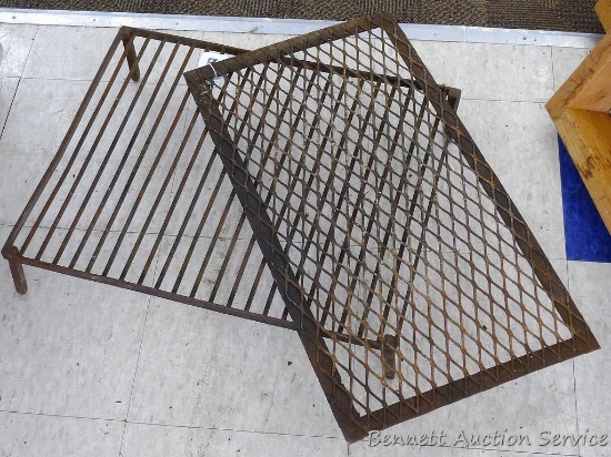 Two metal grates, one has legs and it measures 22" x 18" 4-1/2".