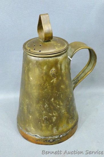 Antique piece has perforated portion on top. Resembles a coffee pot, but doesn't have spout. Stands