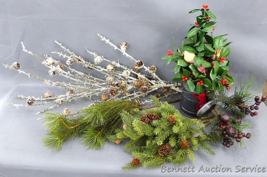 Assorted greenery for decorating. Some pieces have pinecones on.