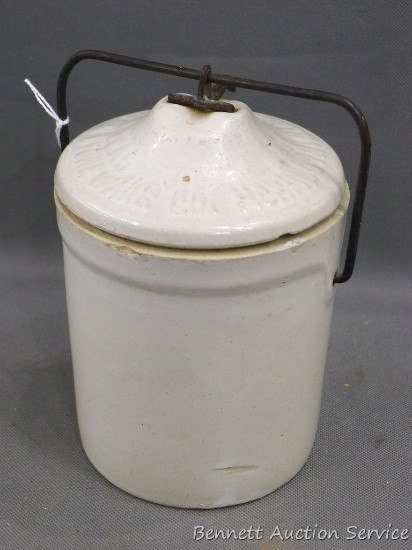 Stoneware crock with bail lid, 4-1/2" w x 5" h. No chips or cracks were noted.