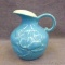 Red Wing art pottery pitcher with magnolia pattern is marked on bottom '1028' and stands 6