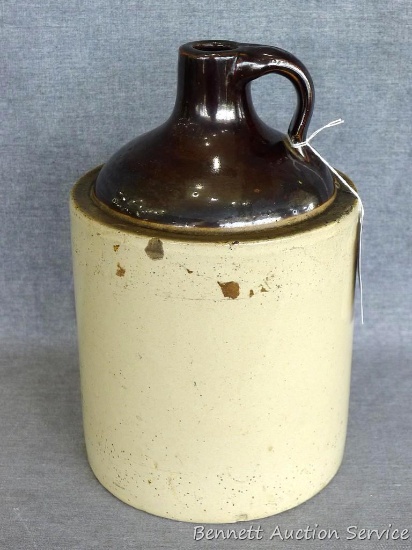 One gallon stoneware jug stands 11" tall and is in overall good condition.