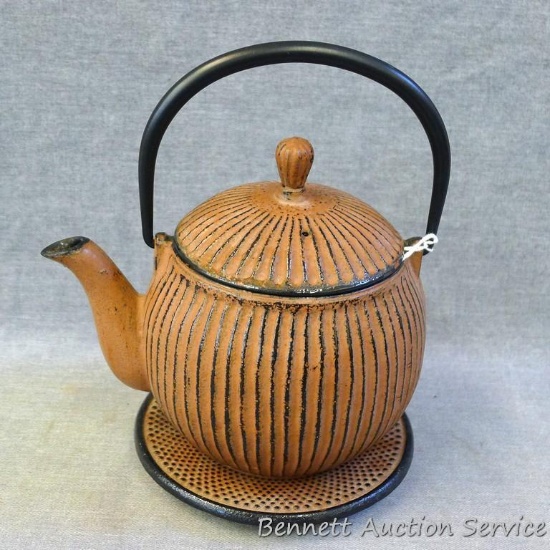 Heavy cast iron tea pot with removable strainer and trivet is in good condition and stands approx.