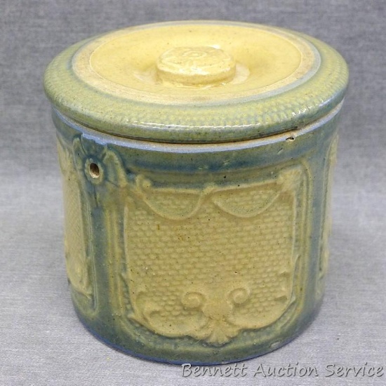 Glazed stoneware jar with lid once had a handle according to the little holes on the sides. Two