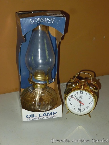 Wind up alarm clock with external bells; Glass oil lamp is new in box, stands approx. 13" tall.