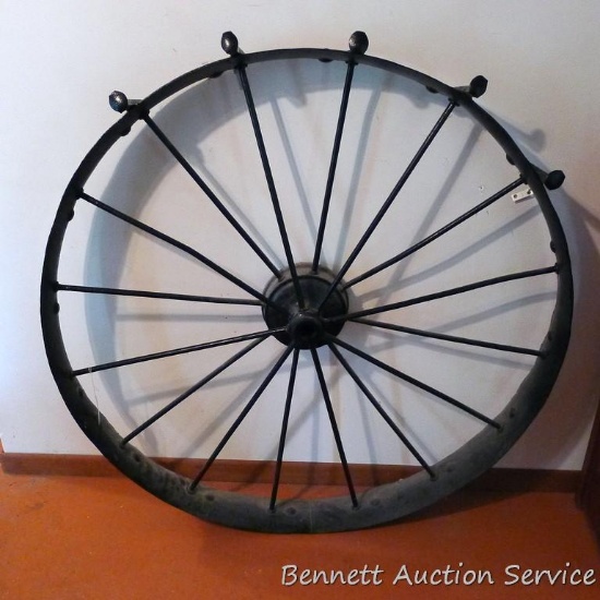 Antique wagon or carriage wheel has been turned into a coat rack. Measures 44"x 6-3/4" at widest