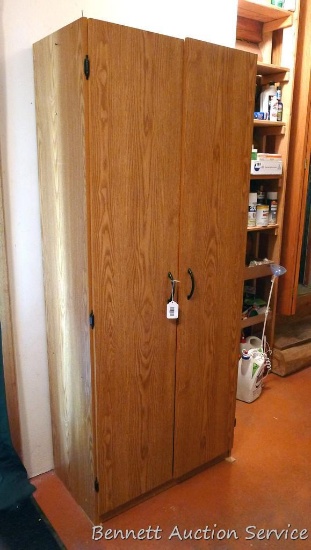 Pressboard wardrobe has four adjustable shelves and a clothes rod. Measures approx 71"x 16"x 30"