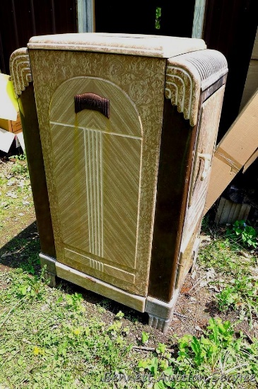Antique Heatflo enameled cast iron wood burner or possibly a coal burner as it has a shaker grate.