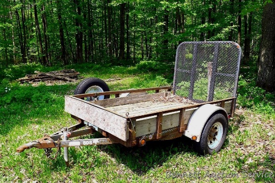 Metal framed trailer with a loading ramp gate. Bed size is 60" x 96". Has 15" tires, aluminum